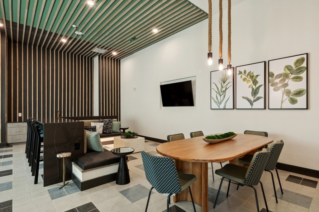 A modern dining room with a wooden table and chairs.
