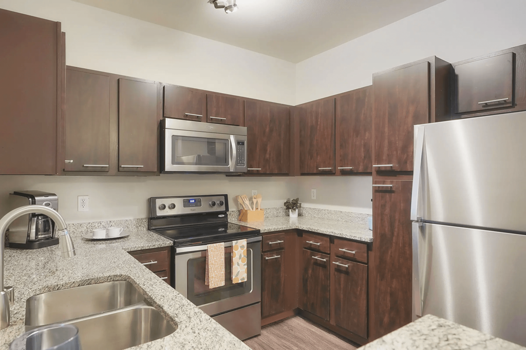 a kitchen with stainless steel appliances and granite counter tops