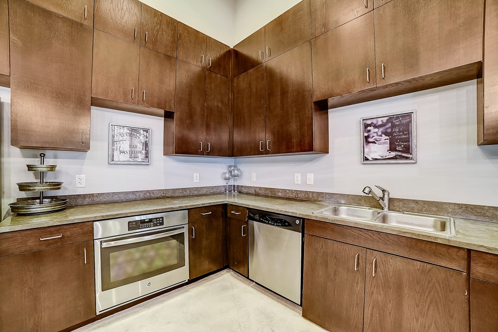 a kitchen with wooden cabinets and stainless steel appliances