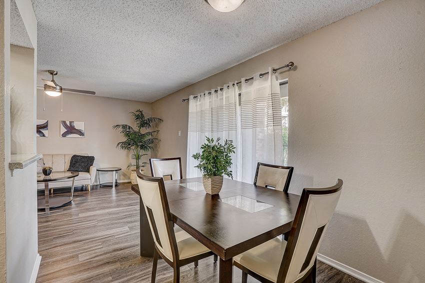 our dining room has a table with chairs and a large window