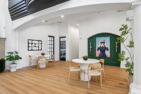 A dining room with a white table and chairs.