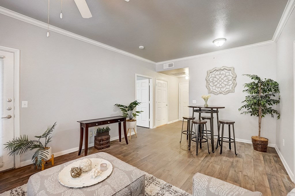 a living room and dining room with a table and chairs