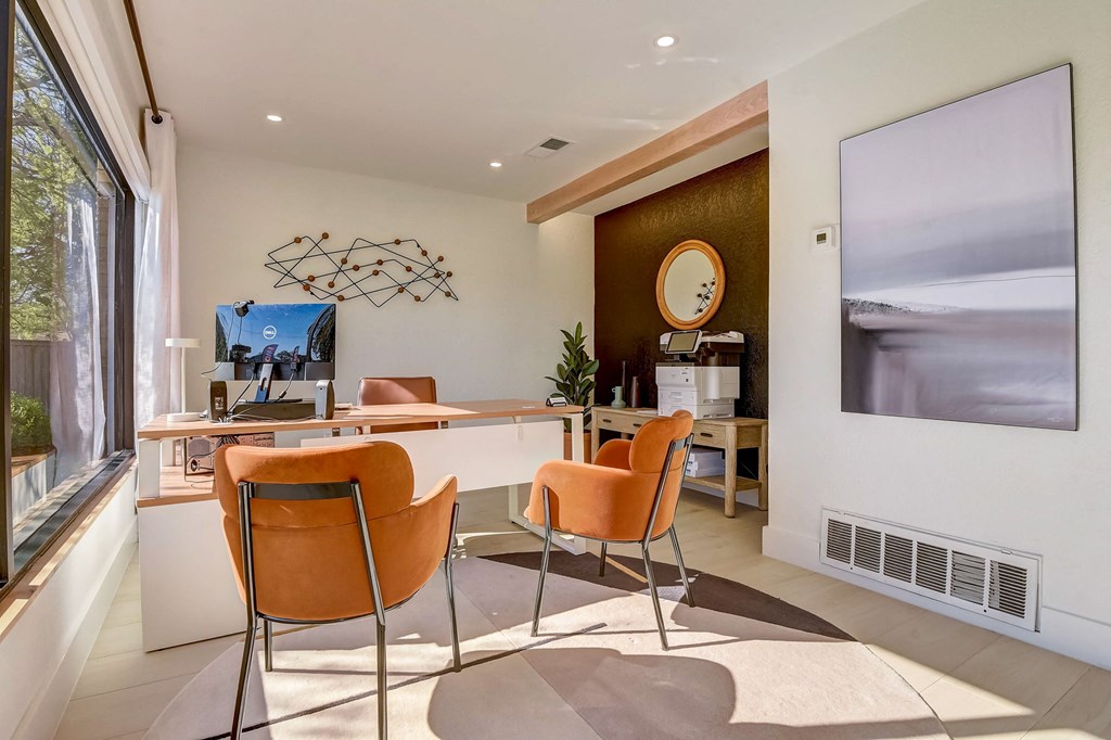 a dining room with a table and chairs and a large window