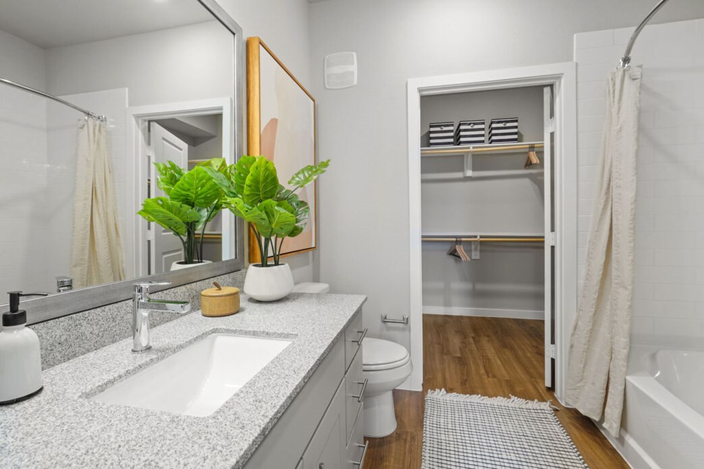 A bathroom with a white sink and a white toilet.