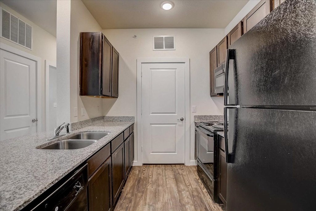 a kitchen with a sink and a refrigerator