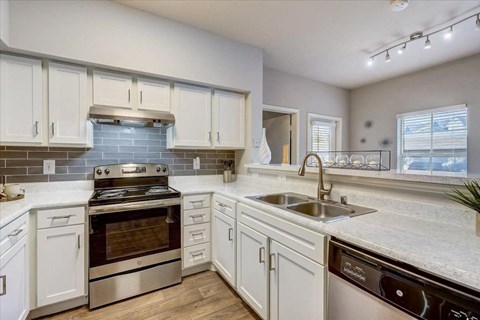 a kitchen with white cabinets and a sink