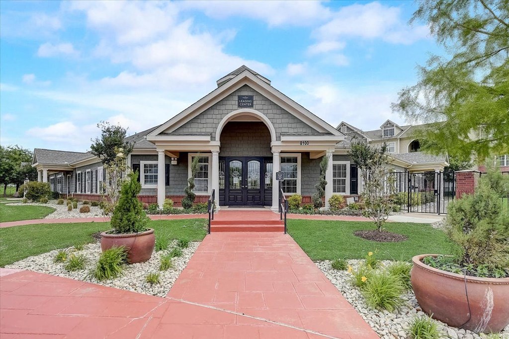 a house with a red walkway in front of it
