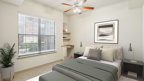 A bedroom with a bed, nightstand, and a ceiling fan.