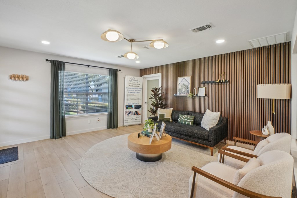 A living room with a couch, chairs, and a coffee table.