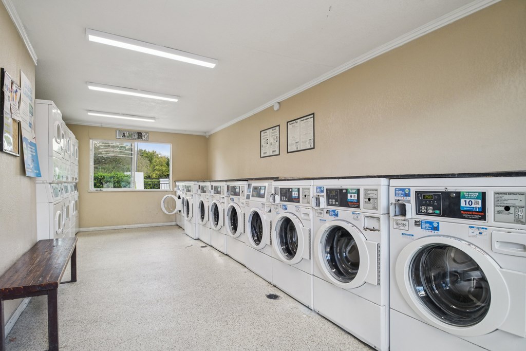 A laundromat with rows of washing machines.