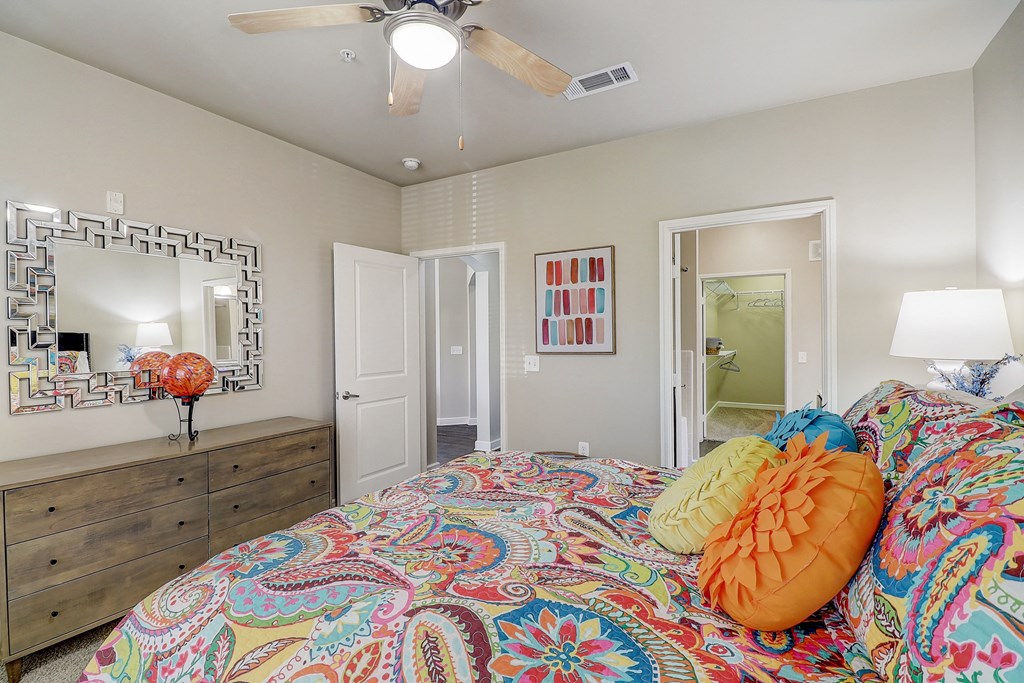 a bedroom with a bed and a ceiling fan