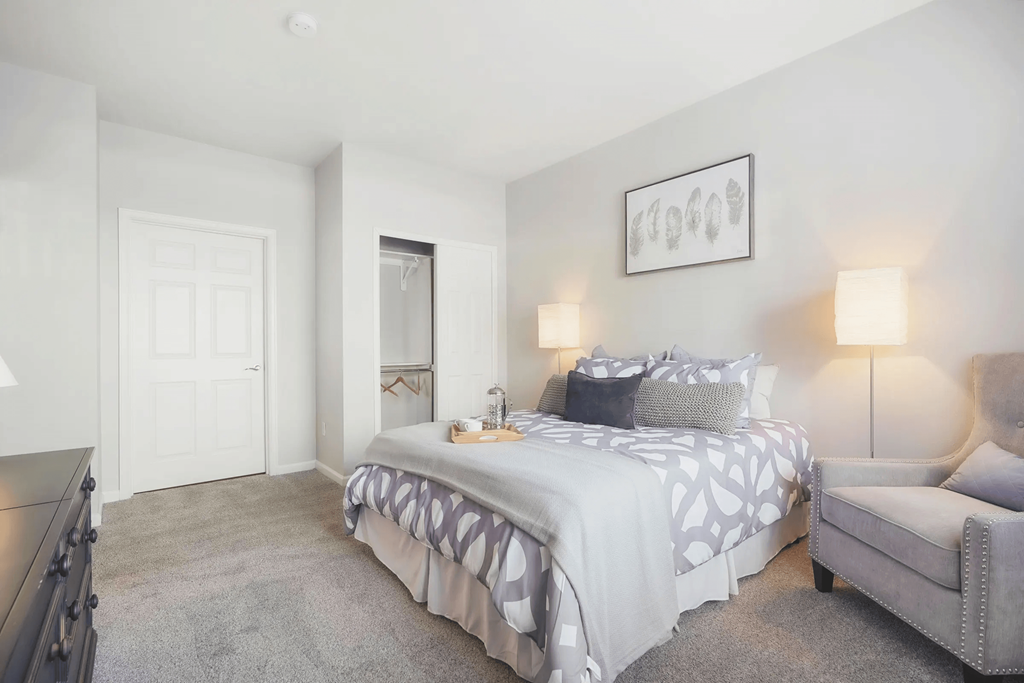 a bedroom with a bed and a chair