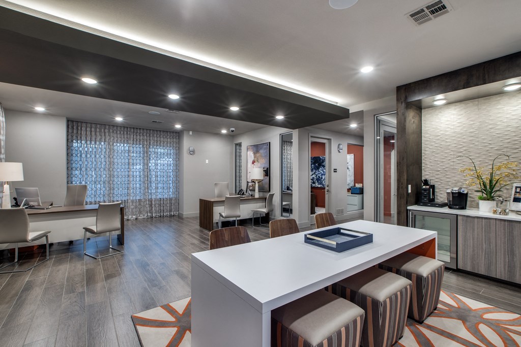 a spacious room with a white table and chairs