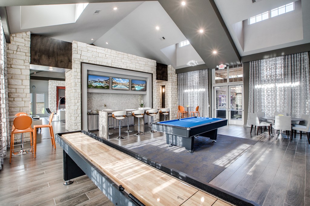 a game room with a pool table and a ping pong table