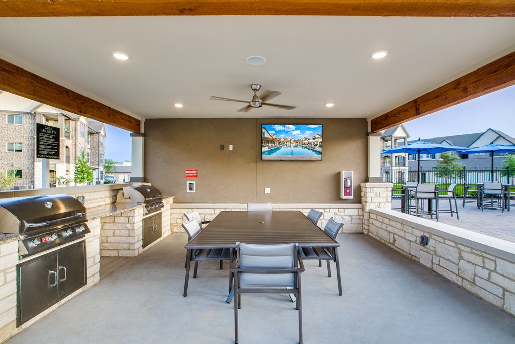 the gathering place at gardner village outdoor patio with table and chairs and barbecue grill