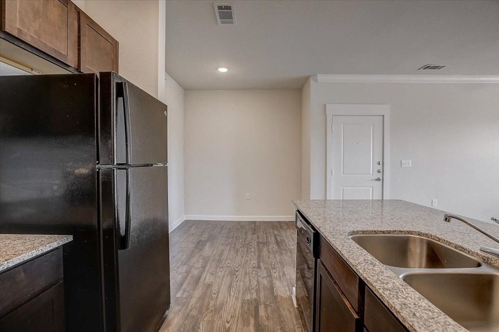 a kitchen with a sink and a refrigerator