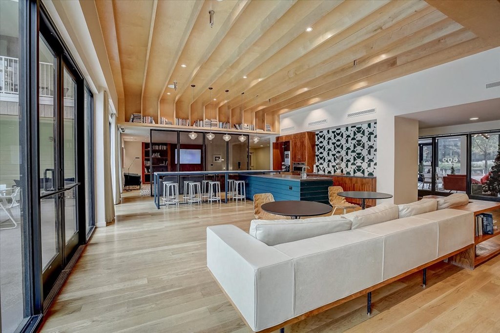 a large living room with a couch and a table