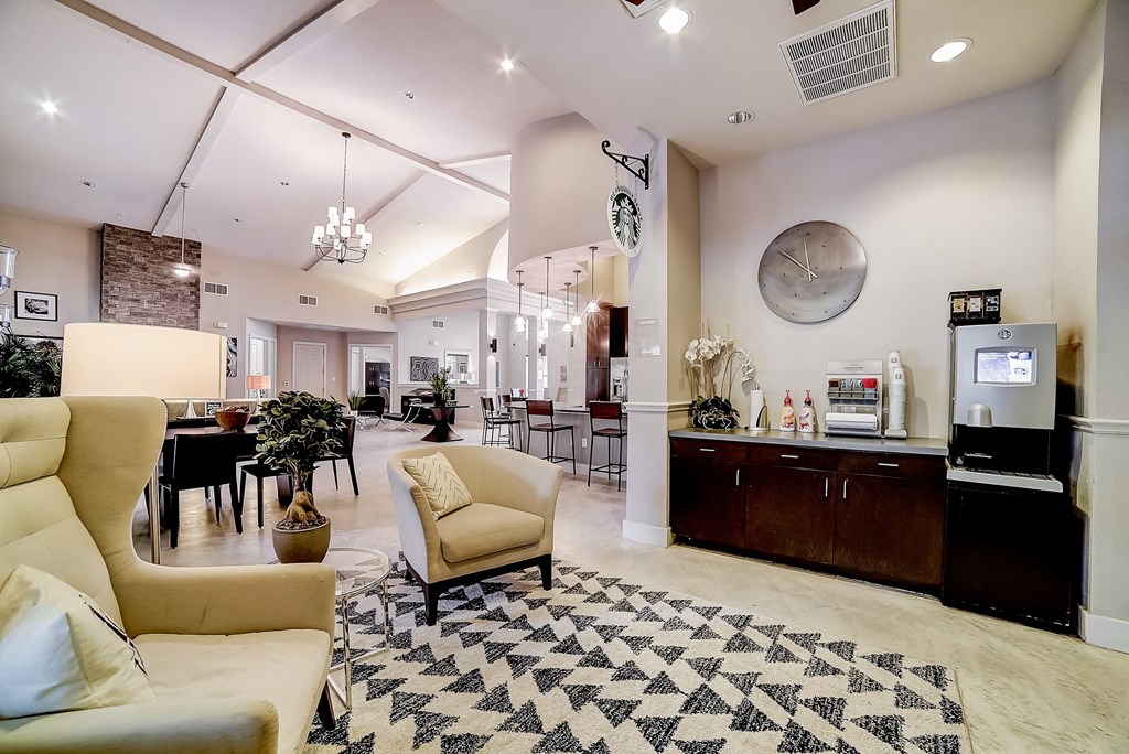 a lobby with couches and chairs and a coffee bar
