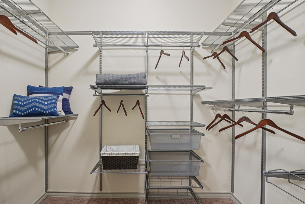 A closet with shelves and hangers.