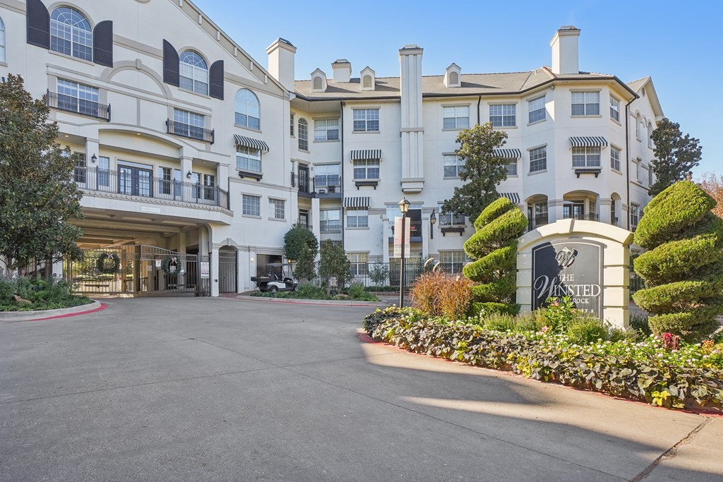 The entrance to a large white hotel with a sign that reads "The Westin".