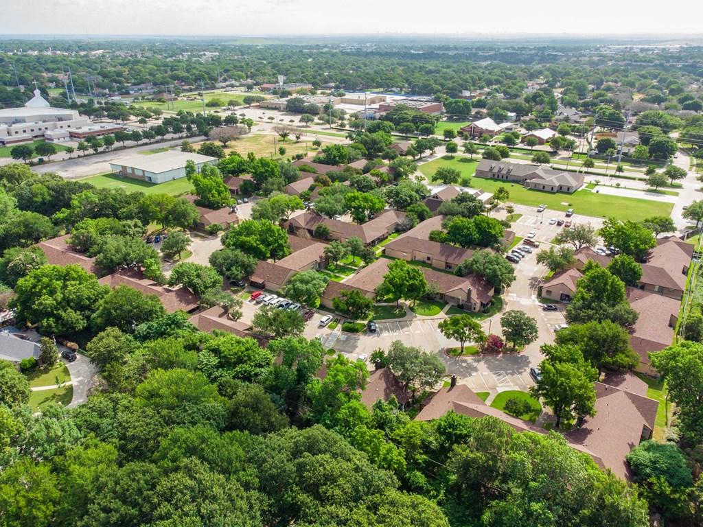 A bird's eye view of a residential area with houses and trees.