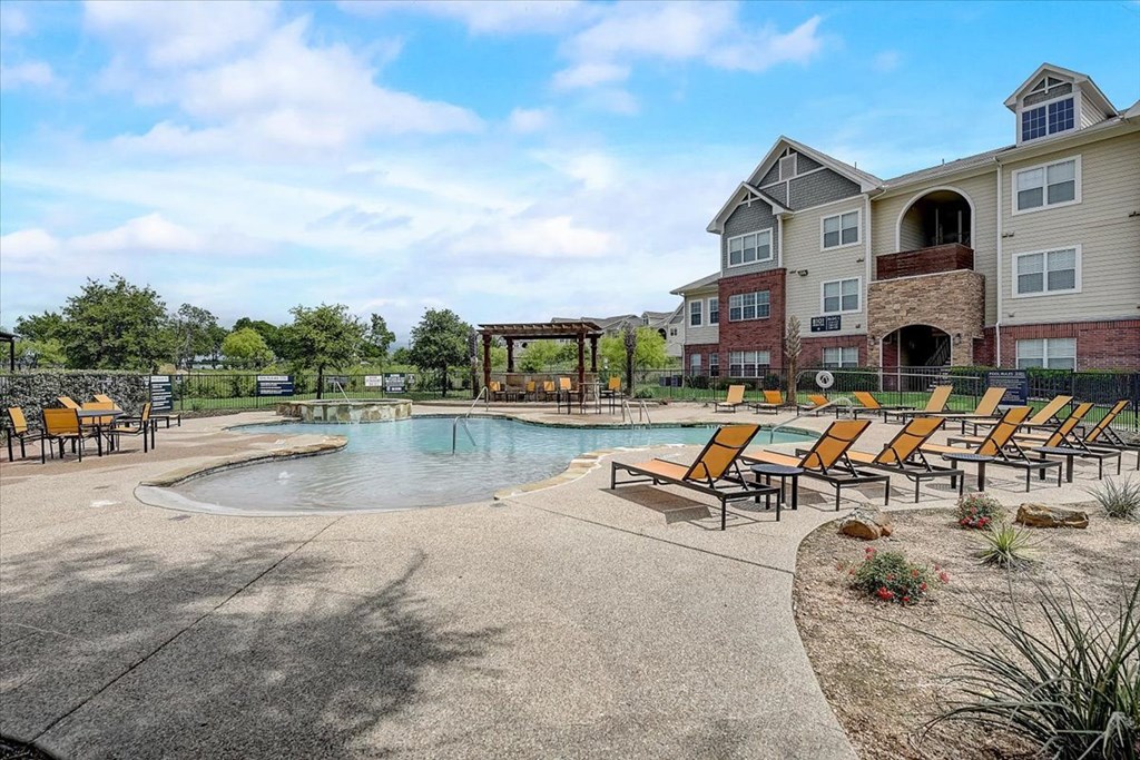 the preserve at ballantyne commons community pool and hot tub with apartment buildings in the background