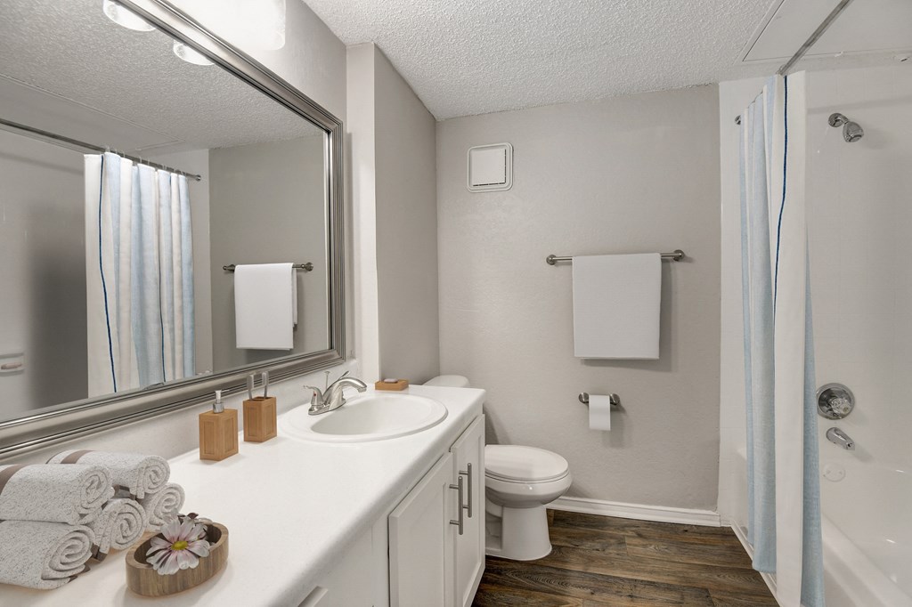 a bathroom with a toilet sink and shower