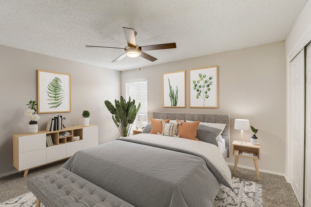 an open bedroom with a bed and a ceiling fan