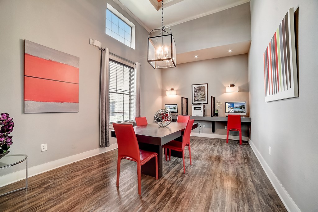 a dining area with a table and chairs and a chandelier