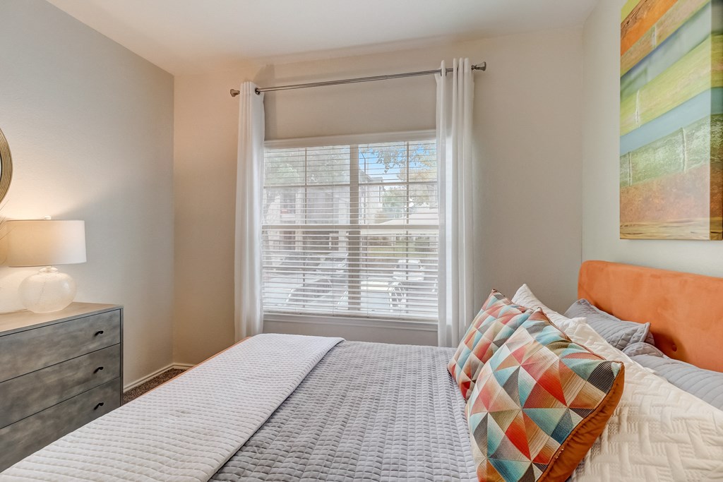 a bedroom with a large bed and a window