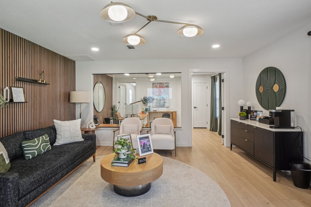 A modern living room with a grey sofa and a wooden coffee table.