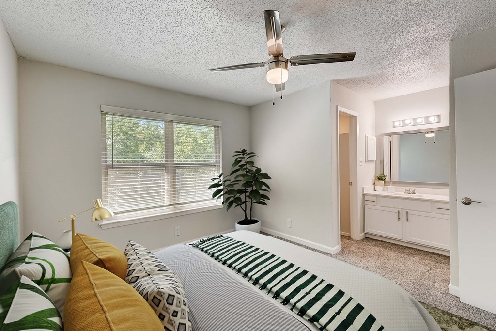 a bedroom with a large bed and a large window