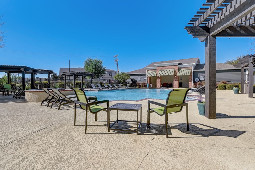 our apartments have a resort style pool with chairs and tables