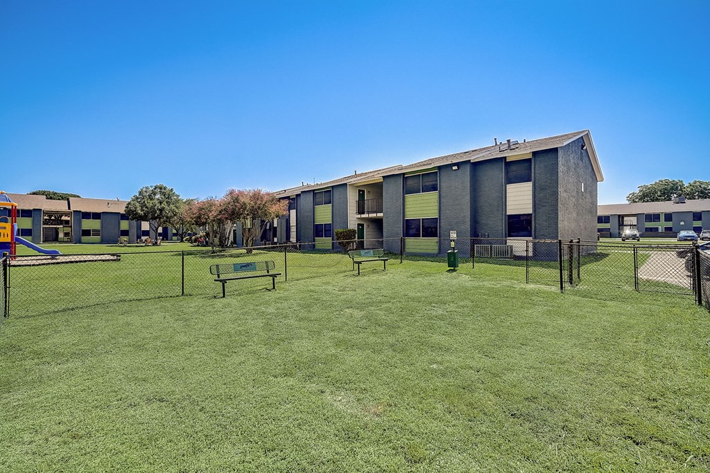 our apartments showcase a dog park with a kennel and agility course
