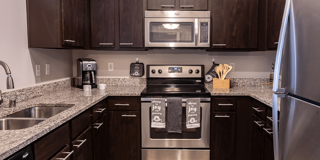 a kitchen with stainless steel appliances and granite counter tops