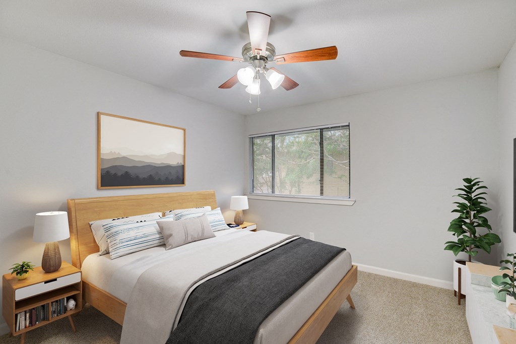a bedroom with a large bed and a ceiling fan