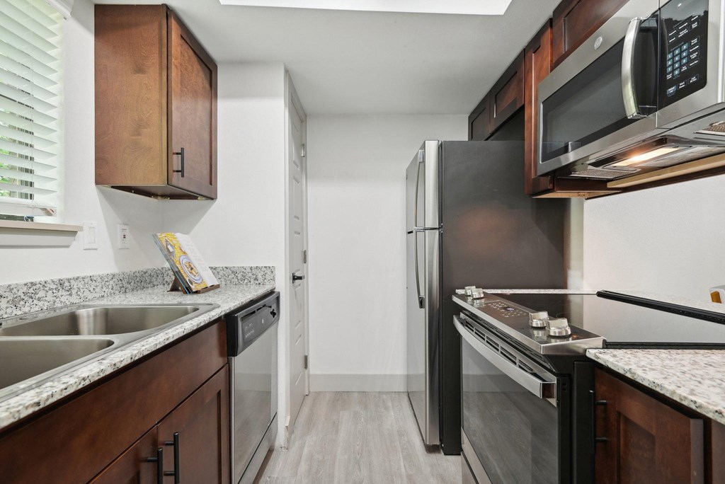 a kitchen with stainless steel appliances and wood cabinetry