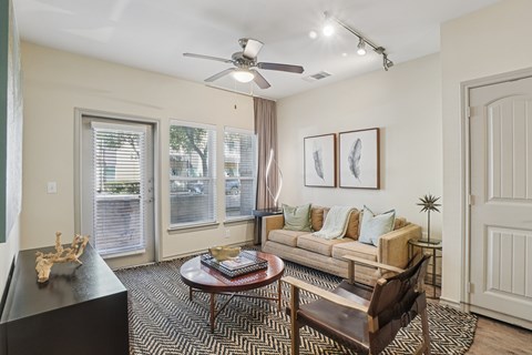 A living room with a black coffee table and a brown chair.