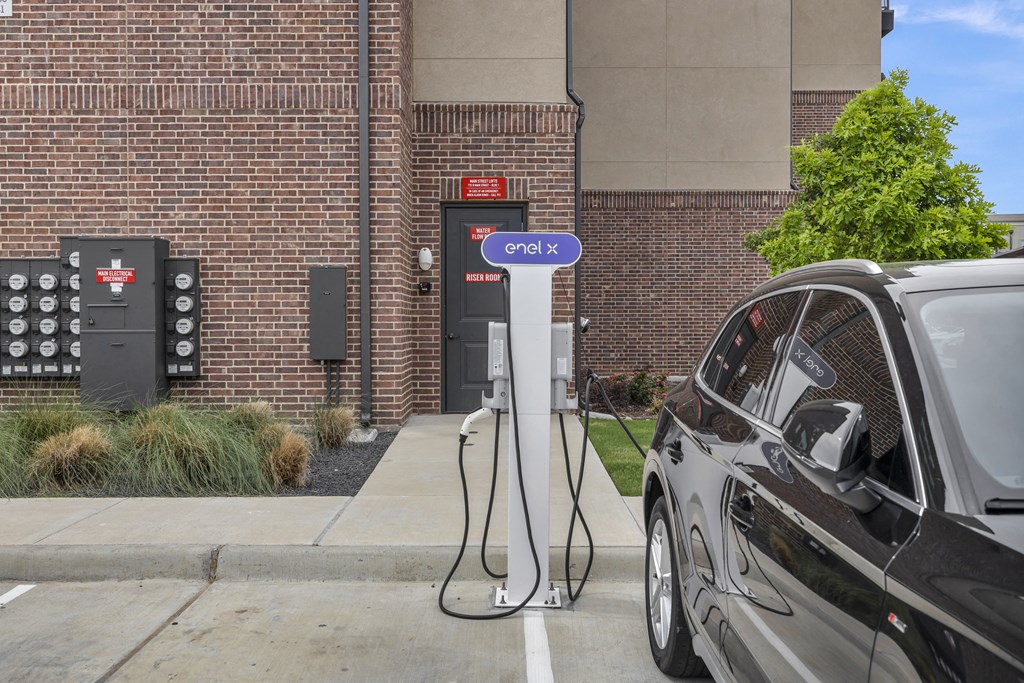 a car plugged in to a electric charger at a charging station