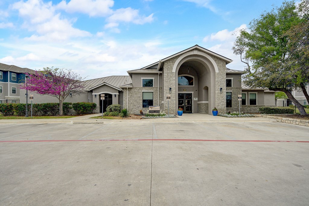an empty parking lot in front of a building