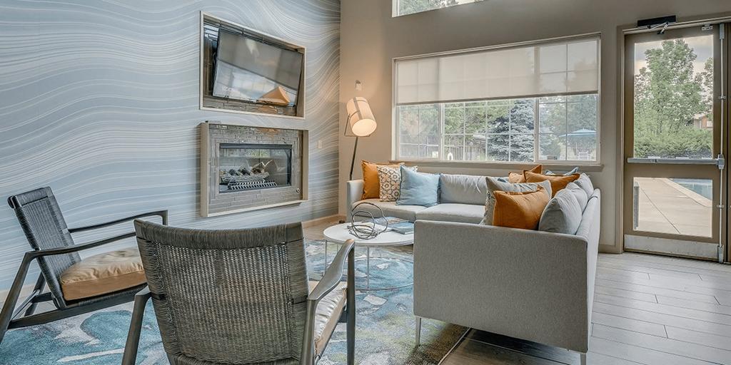 a living room with a couch and chairs and a fireplace