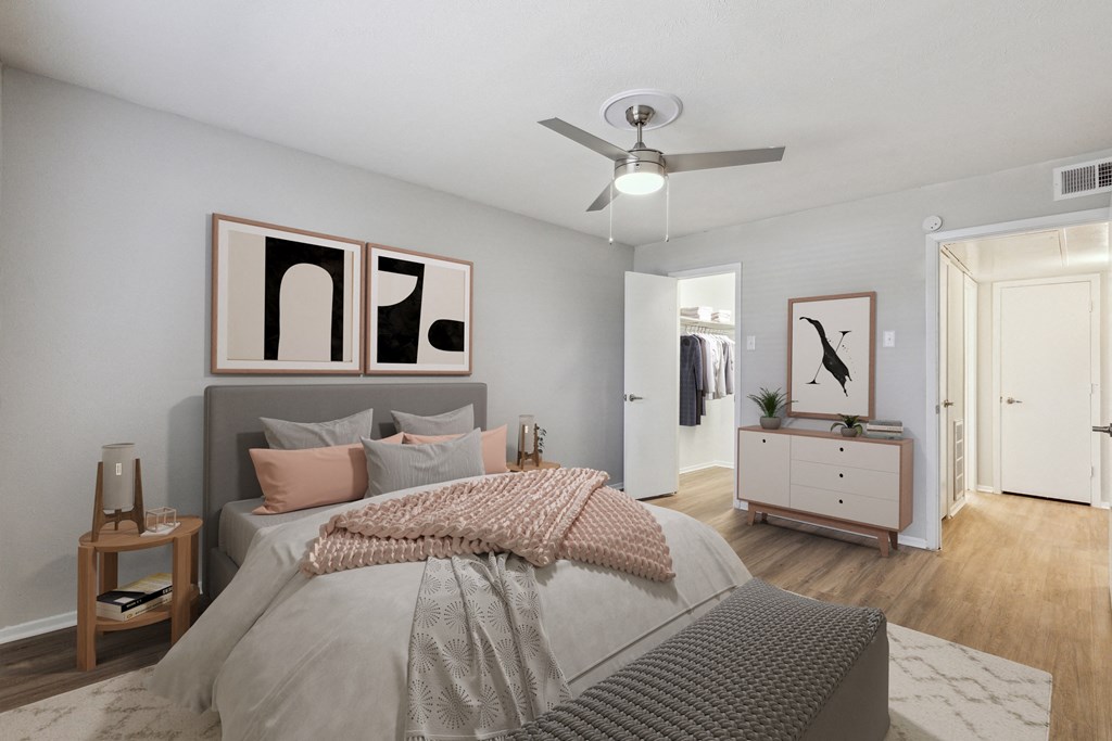 a bedroom with a large bed and a ceiling fan