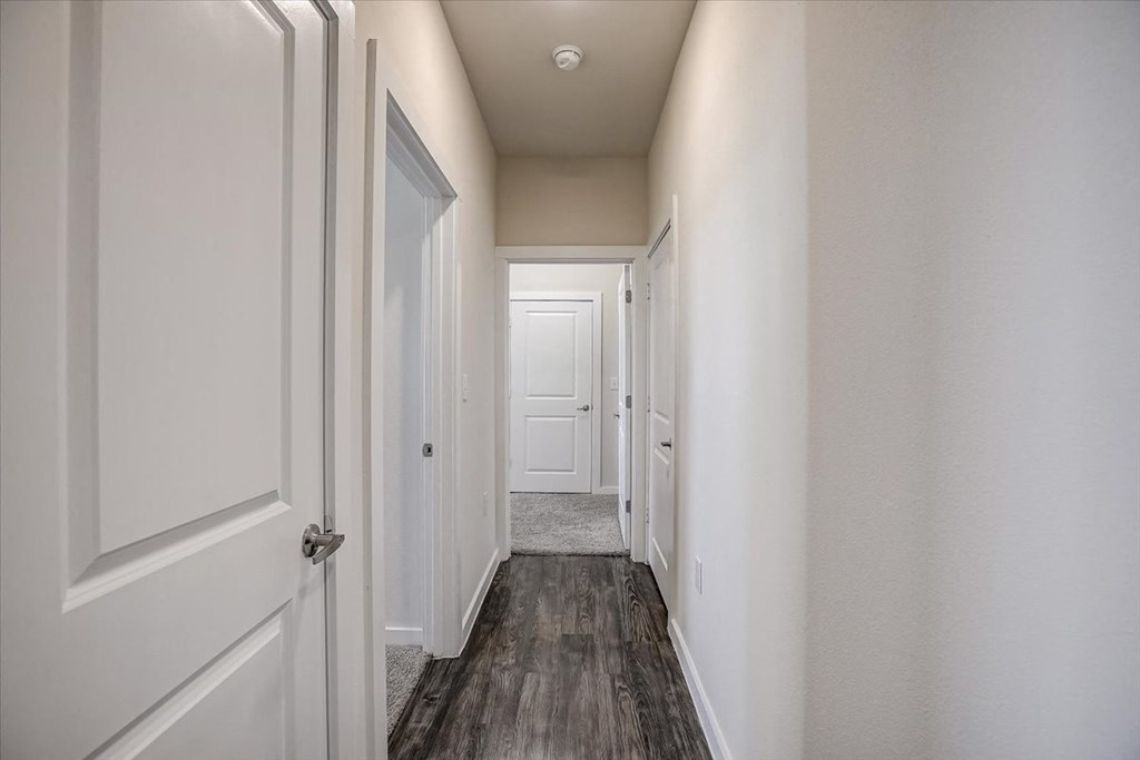 our apartments offer a spacious hallway with wood floors and white walls
