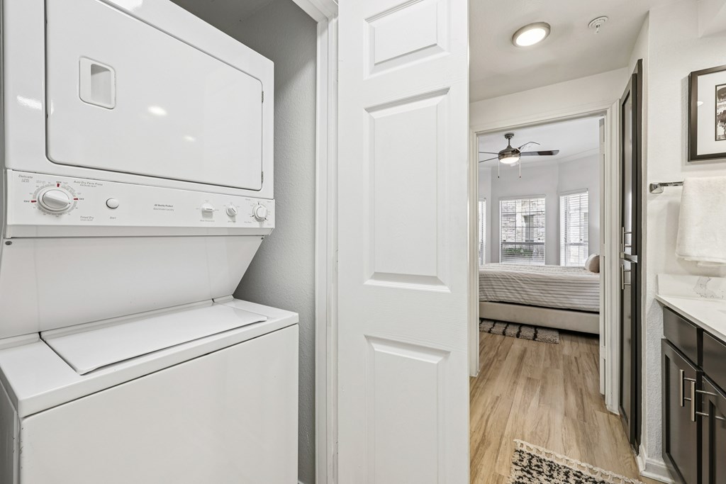 A white washing machine and dryer in a small laundry room.