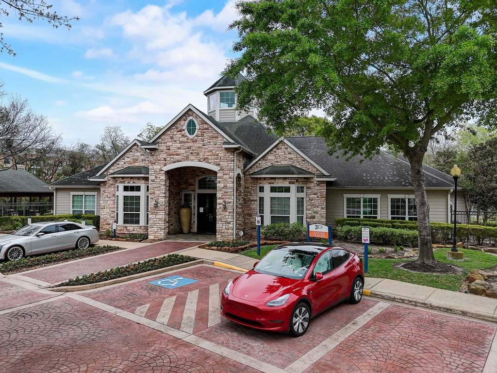 a red car parked in front of a house