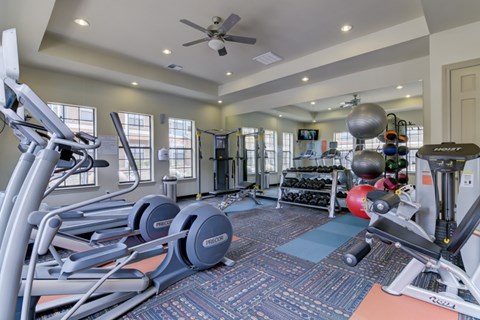 A spacious home gym with a variety of exercise equipment.