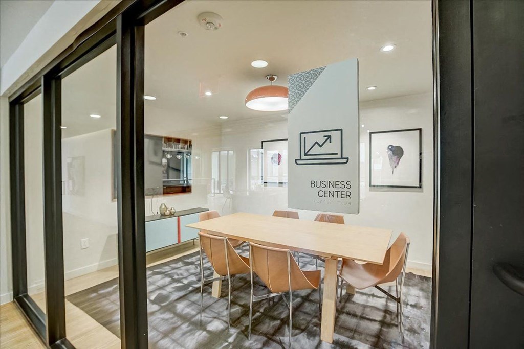 a conference room with a wooden table and chairs