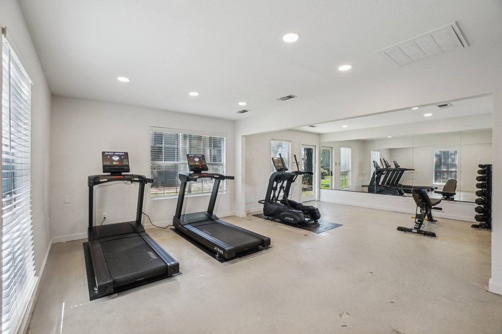 A spacious room with treadmills and exercise equipment.