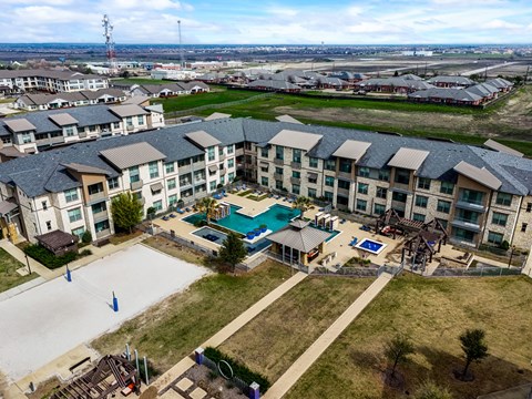 an aerial view of an apartment building with a swimming pool