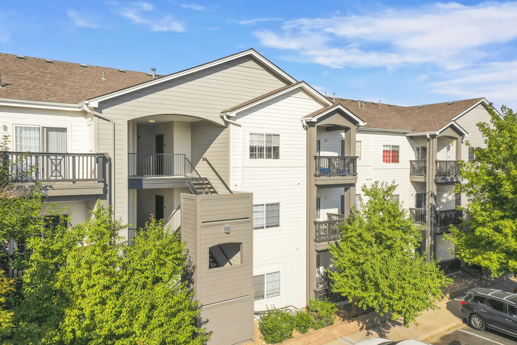 the outlook of an apartment building with balconies and trees